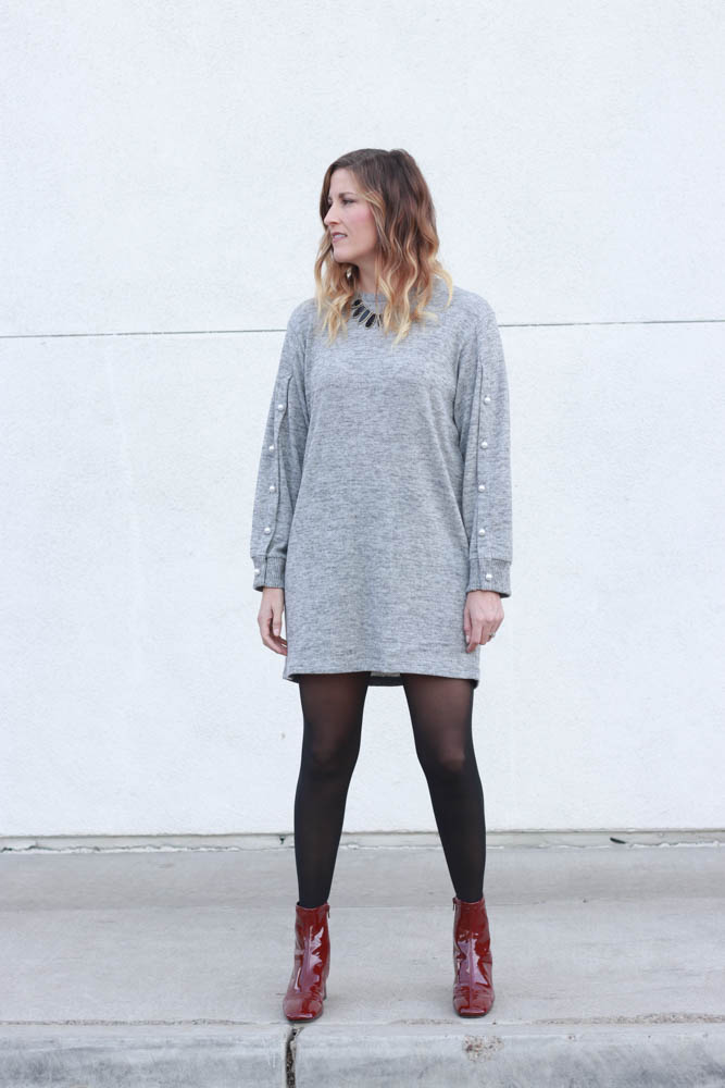 A great sweater dress with pearl sleeve detail and red patent leather boots. - Grey Sweater Dress by popular Los Angeles fashion blogger The Fashionista Momma