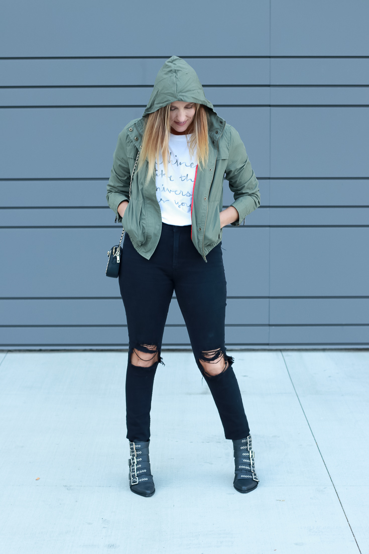 The Fashionista Momma shares hooded military jacket with a graphic tee and black denim.