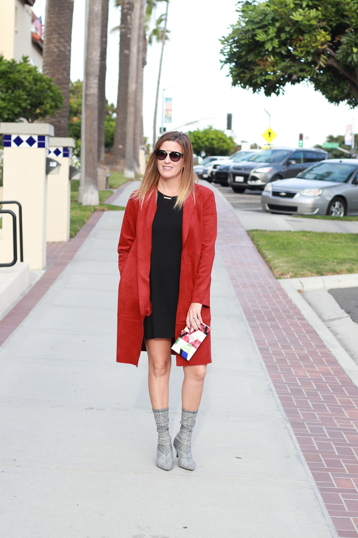 The Fashionista Momma shares the perfect pair of sock ankle boots with a dress and suede jacket.