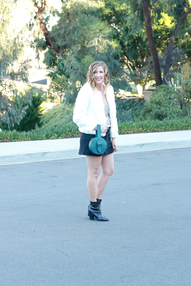 The Fashionista Momma styles a sequin top with a suede skirt and fur coat.