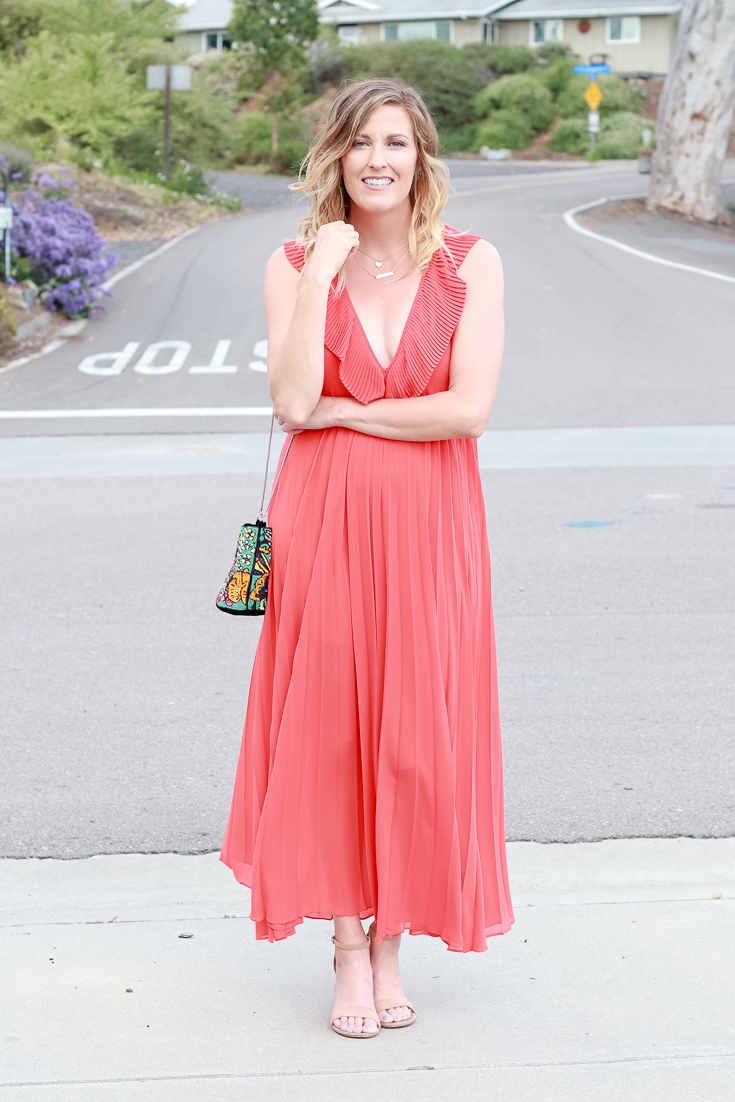 The Fashionista Momma shares an orange dress that is perfect for a night out.